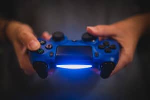 blue gaming controller in hands