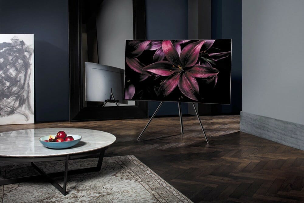 QLED TV with a flower as a background