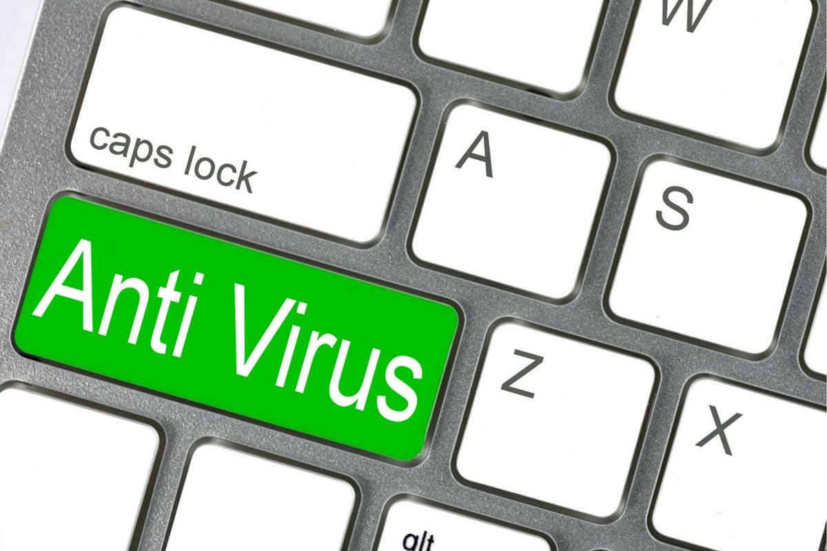 green anti virus key on white keyboard