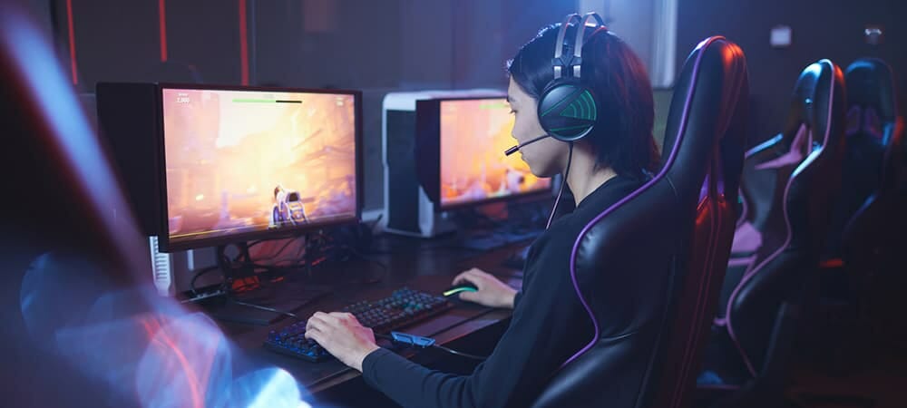 Woman playing games on two monitors