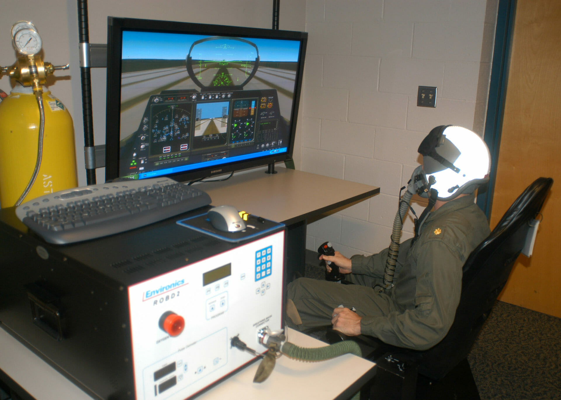 A pilot simulating a flight on a monitor