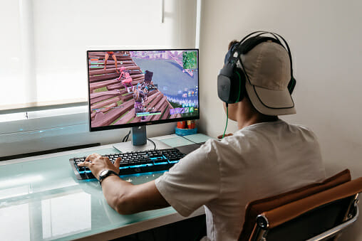Man playing fortnite on a monitor
