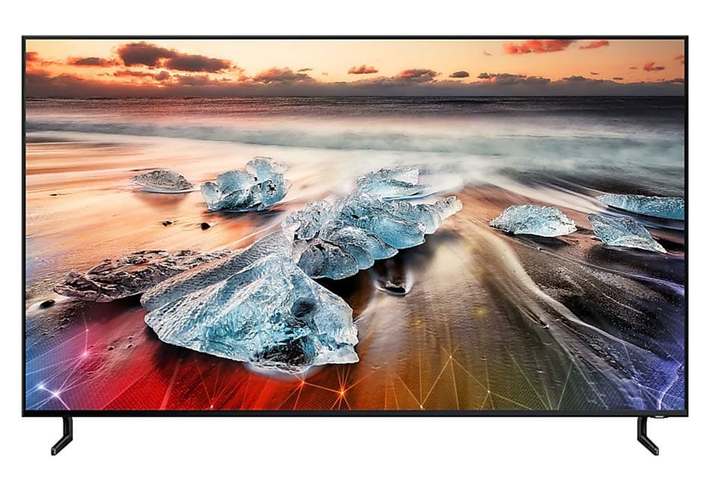 A big TV with a sea and rocks as a background