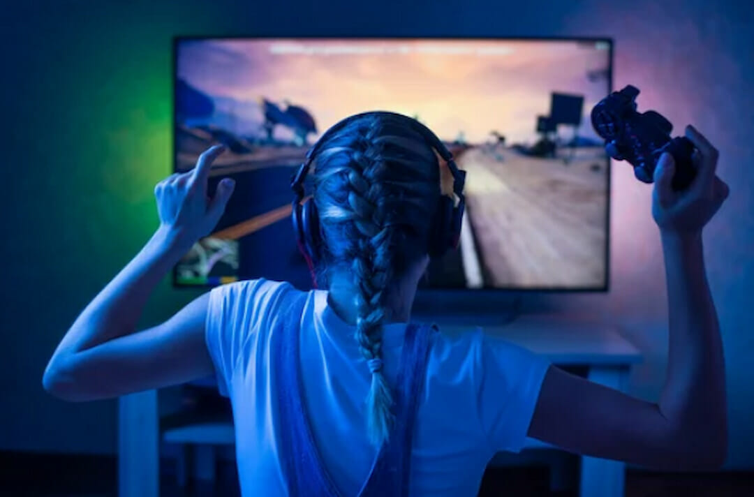 a girl holding a joystick and playing the game