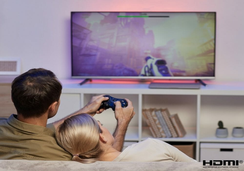 Couple playing a game on a big monitor