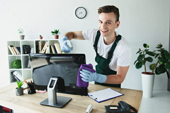 Boy cleaning a monitor