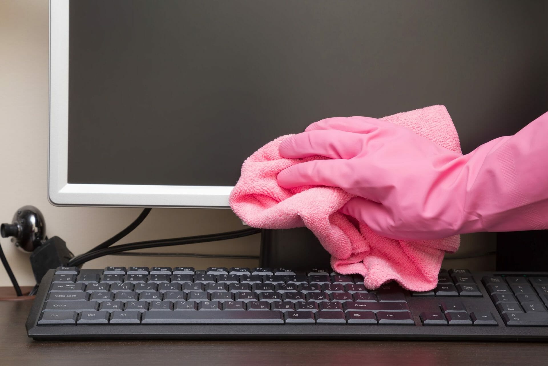 Wiping the monitor with a pink rag