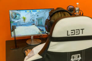 a person sitting in the chair and playing a video game