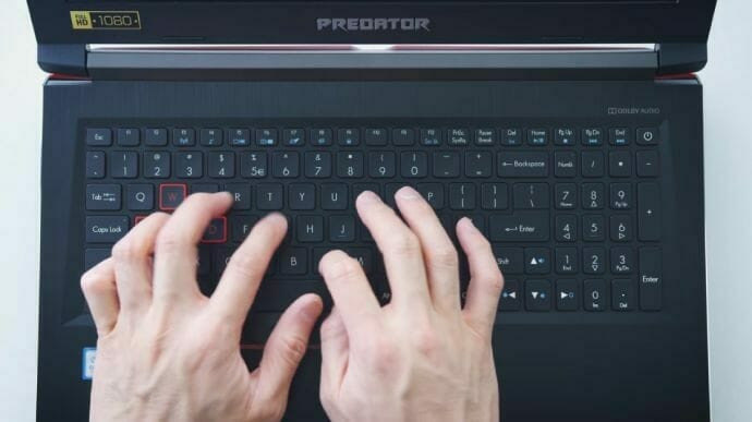 a person typing on the laptop keyboard