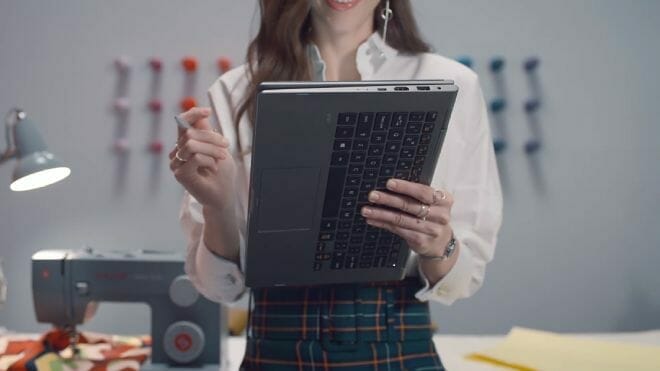 Woman holding a foldable laptop