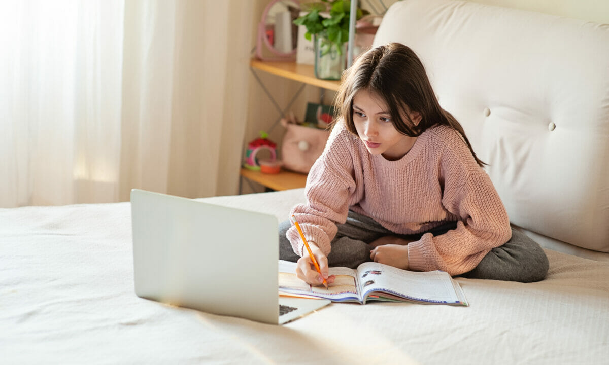 a girl on the bed with her laptop