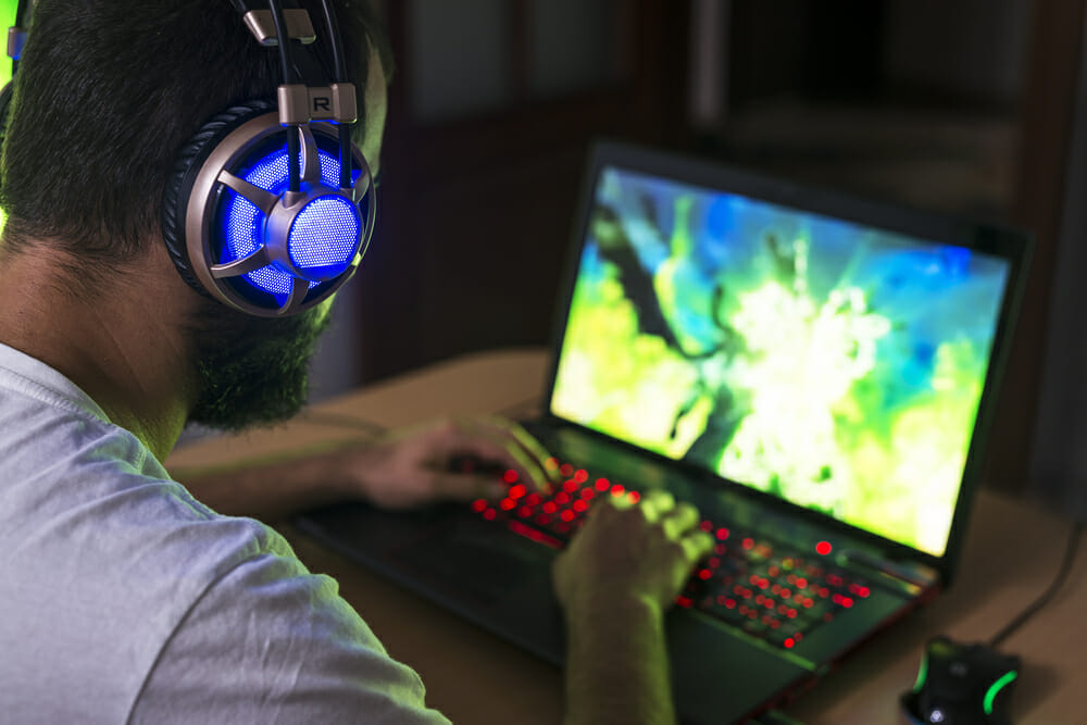 guy playing a game on a laptop