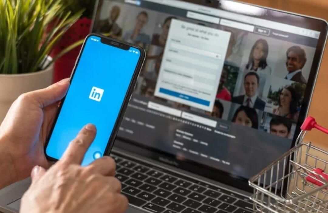 a person using a cell phone with Linkedin logo on the screen