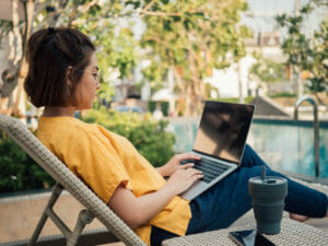 Woman sitting outside with a laptop in her lap