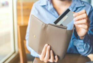 a person putting credit card in a wallet