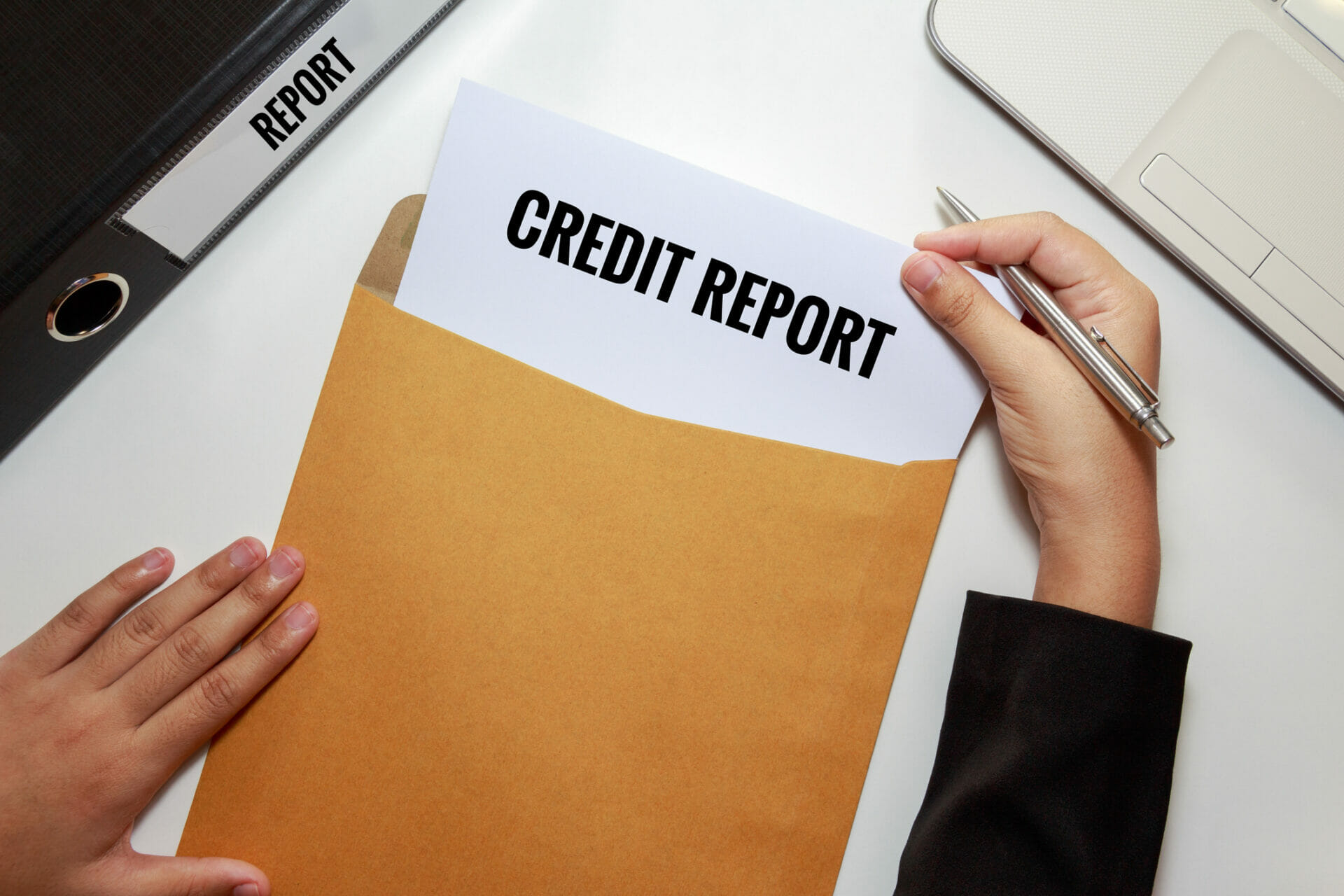 Credit report in an envelope opened by a man
