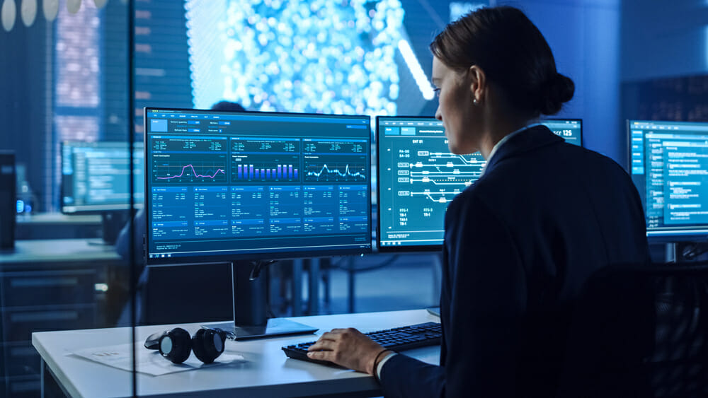 Woman in a suit hacking on a computer