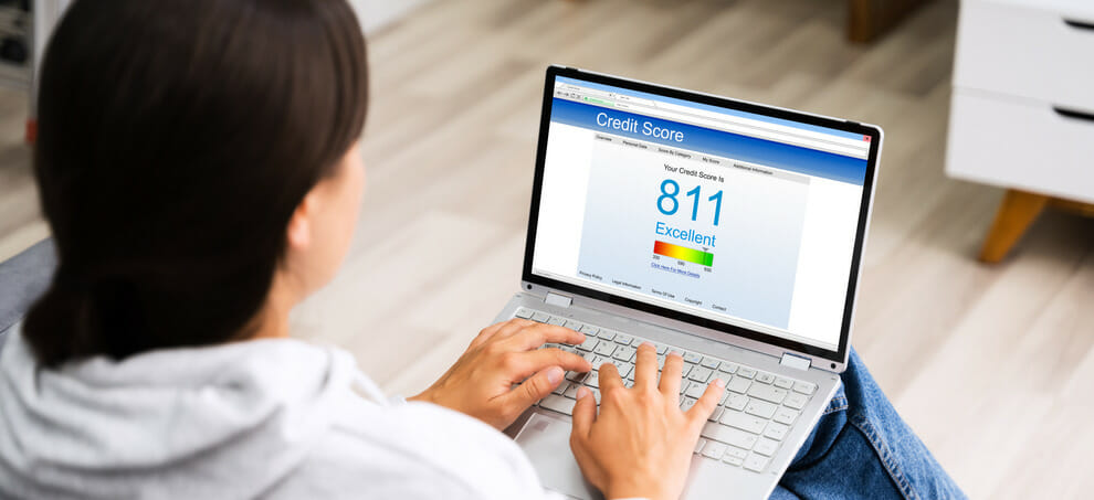 Woman looking on her credit score on a laptop