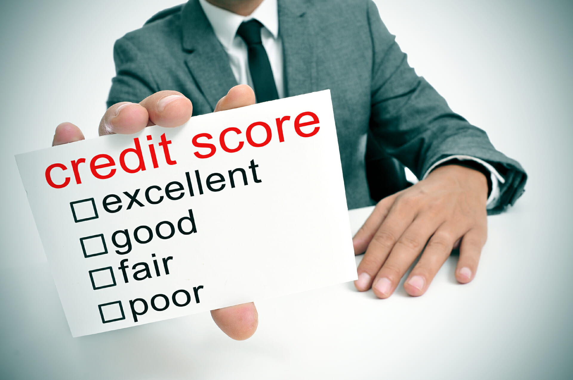 Credit score card held by a man