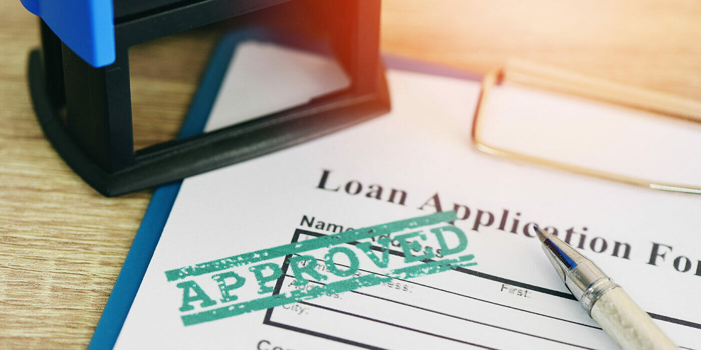 Loan application form with a green stamp of approval