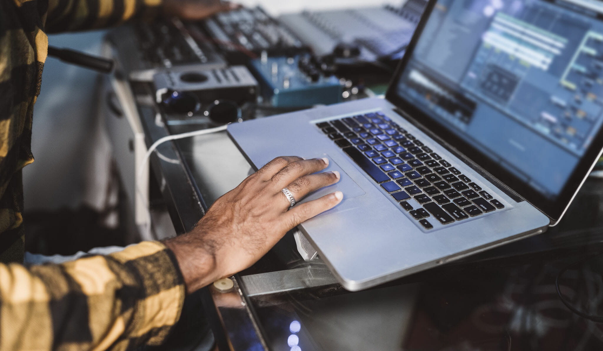 A man using a laptop for music production