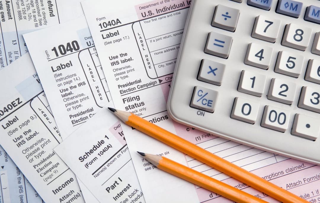 Tax forms, pencils and calculator